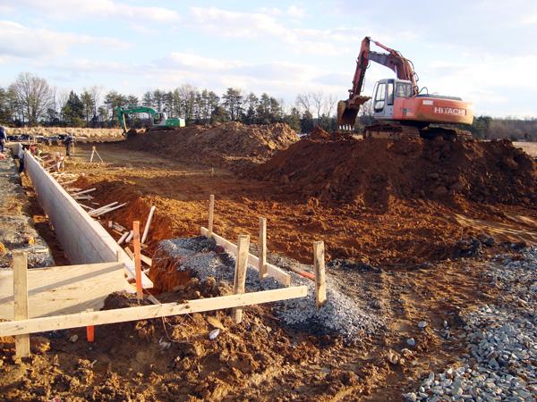 Excavation and concrete forms during early-stage construction