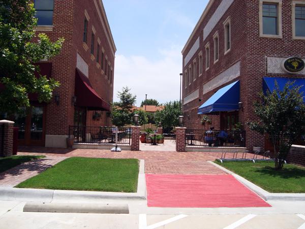 Brick mixed-use retail center with landscaped walkway